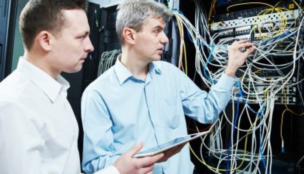 depositphotos_117811212-stock-photo-two-network-support-engineers-administrating