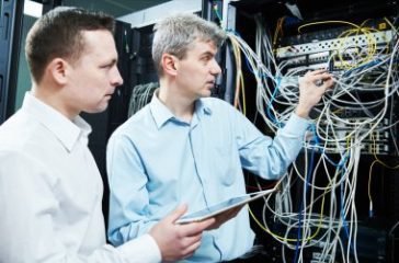 depositphotos_117811212-stock-photo-two-network-support-engineers-administrating